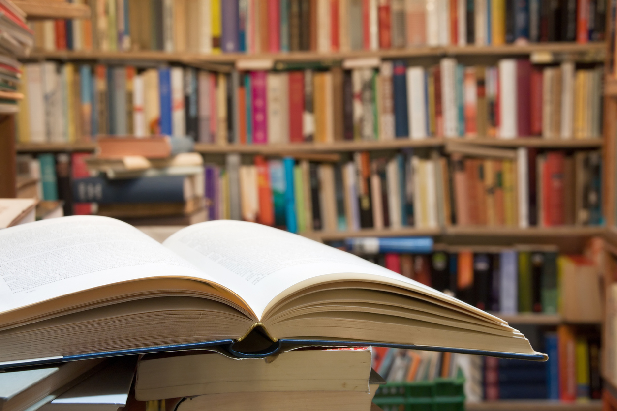 Old open book with library background